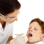 Dentist Examining Little Boys Teeth