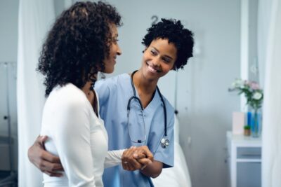 Medical assistant helping a patient